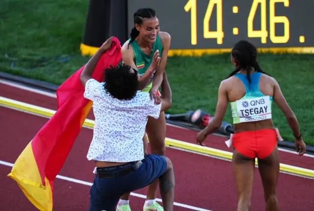 Ethiopia's Letesenbet Gidey with a spectator on the track after the women's 5000 metres final