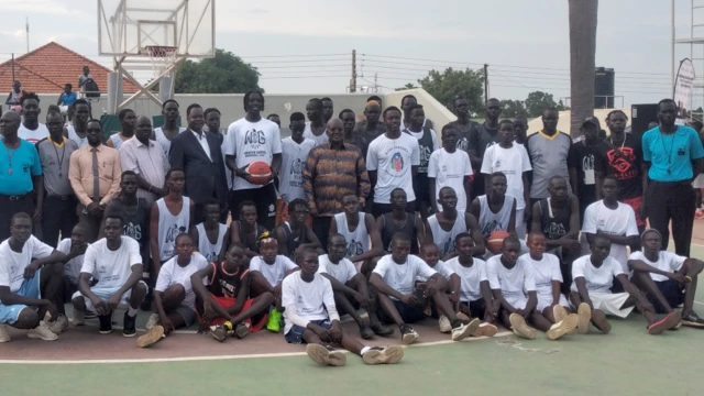 Wenyen Gabriel, holding a ball, pictured at the end of a basketball camp for young South Sudanese basketball players - Monday 25 July 2022