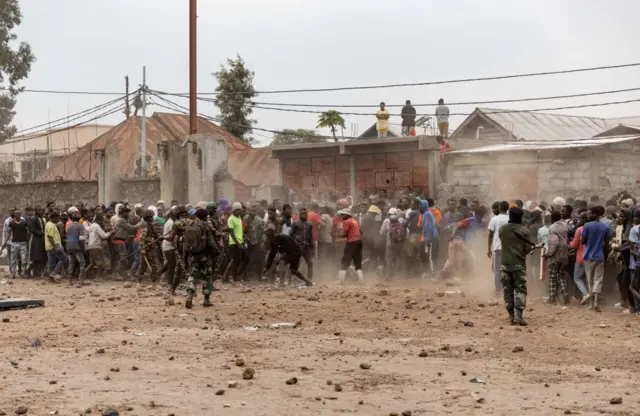 Soldiers try to control a crowd outside a UN base in Goma, DR Congo - 26 July 2022