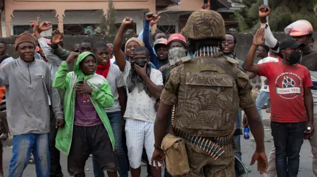 Congolese policemen stand guard to stop protesters near the compound of a United Nations peacekeeping force's warehouse in Goma in the North Kivu province of the Democratic Republic of Congo July 26, 2022