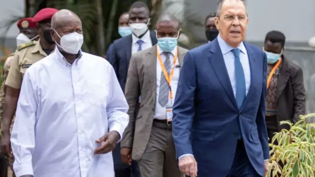 Ugandan President Yoweri Museveni (L) walks with Russian Foreign Minister Sergei Lavrov (R) at the State House in Entebbe, Uganda, on July 26, 2022