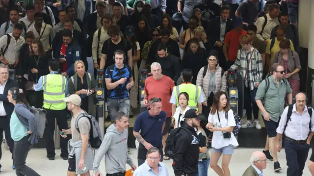 Passengers pile off one of the few trains arriving at Waterloo station this morning