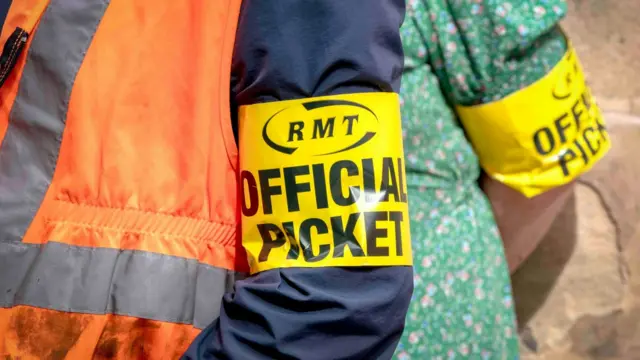 RMT members on the picket line outside Edinburgh's Waverley Station on 25 June