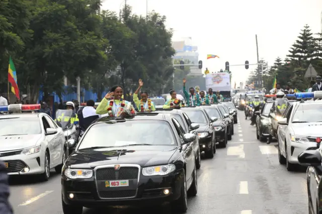 Athletes greet the crowd during a welcoming ceremony in Addis Ababa