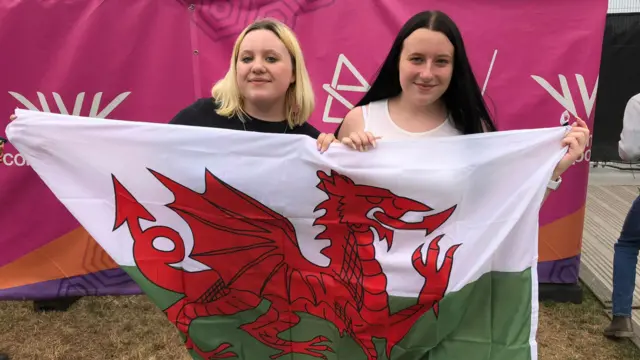 Grace and Abbi Colley holding a Welsh flag