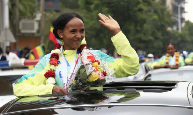 Athletes greet the crowd during a welcoming ceremony in Addis Ababa