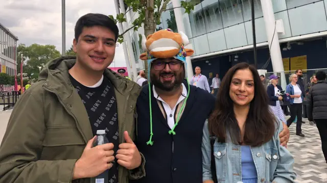 A son, father and mother with a bull hat on the father