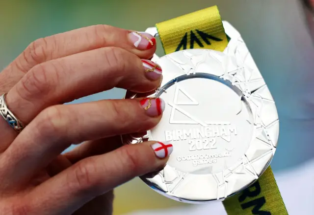 English triathlete Georgia Taylor-Brown displays her silver medal, plus nails painted in the England colours