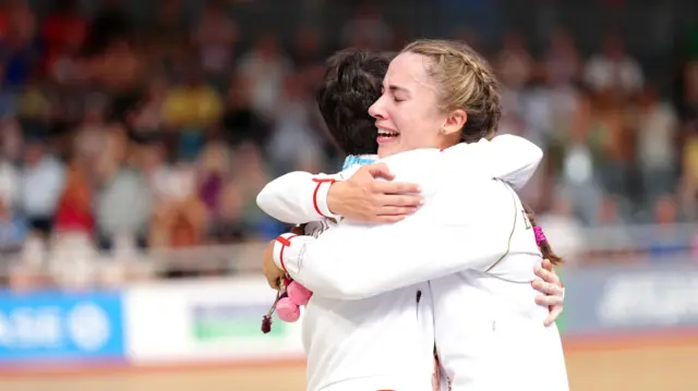 Sophie Unwin and Georgia Holt embrace on the podium at the Commonwealth Games