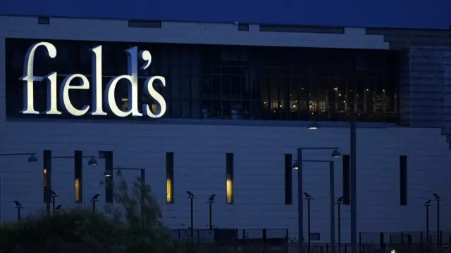 The logo of the Field's shopping centre on the side of the building is pictured after dark