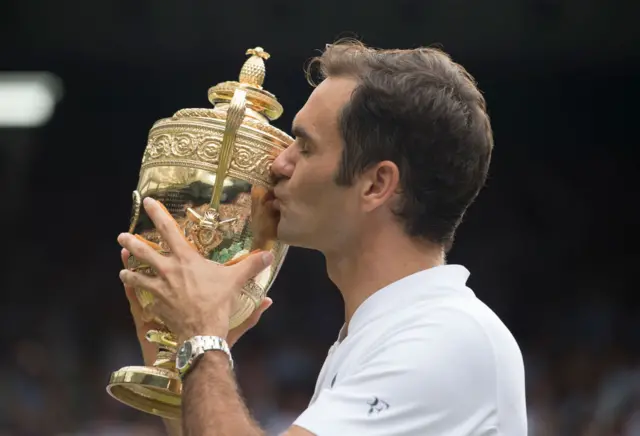 Roger Federer kisses WImbledon trophy