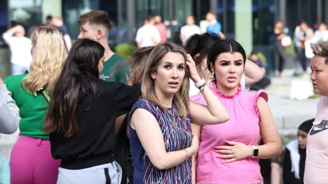 Two women look concerned outside Field's shopping centre