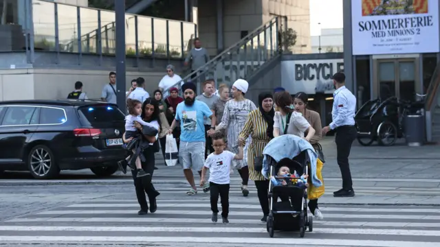 People flee the Fields shopping centre during evacuation by armed police