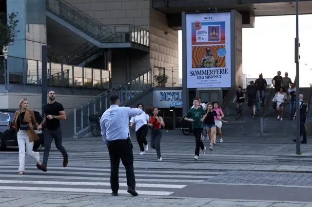 People running out of Field's shopping mall in Copenhagen