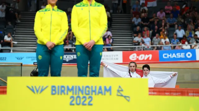 Sophie Unwin and Georgia Holt pose behind the podium