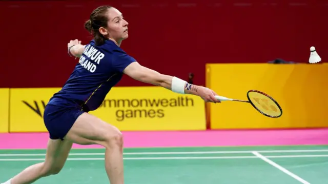 Scotland's Kirsty Gilmour stretches for a return in her Commonwealth Games match against Canada's Michelle Li