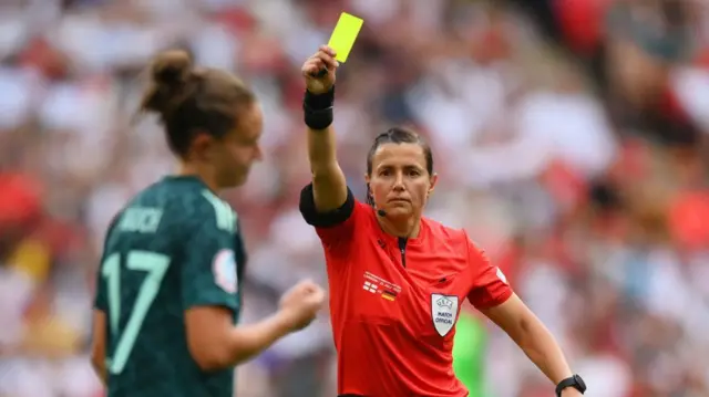 Kateryna Monzul shows a yellow card