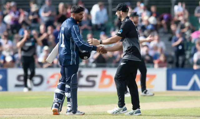 Hamza Tahir and Darryl Mitchell shake hands