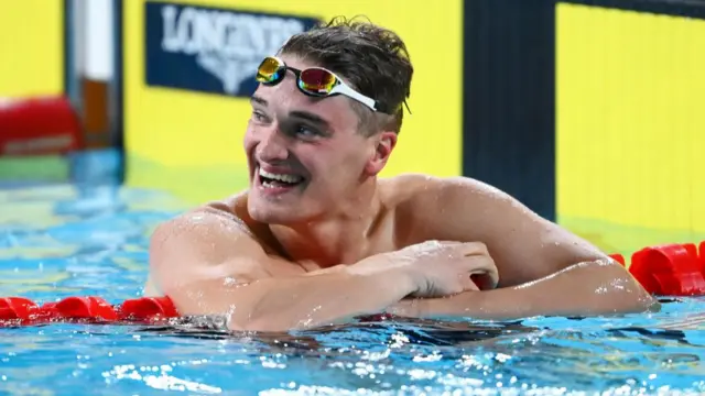 England's James Wilby celebrates winning 100m breaststroke gold