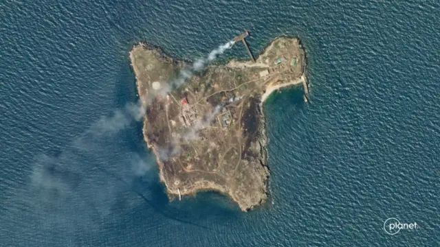 A satellite image shows smoke rising from Snake Island, off the coast of Ukraine, 29 June 2022