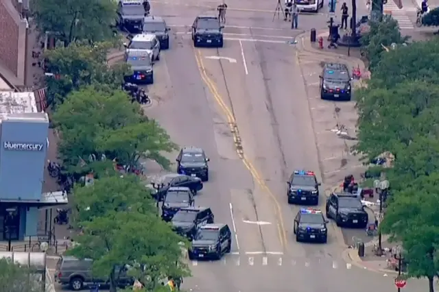 Police deploy after gunfire erupted at a Fourth of July parade route in the wealthy Chicago suburb of Highland Park, Illinois,