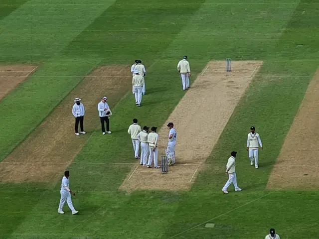 India players surround Alex Lees after the wicket of Ollie Pope