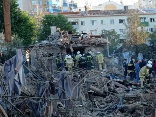 Rescue workersat the site of a destroyed residential building after the blasts in Belgorod,
