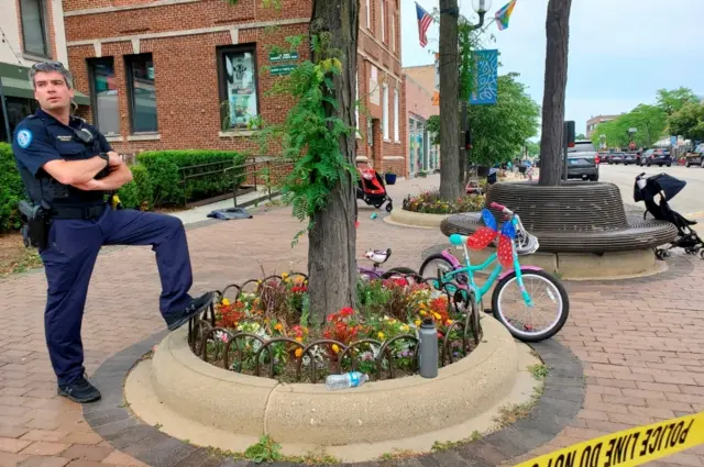 Police officer guards the scene after a mass shooting at Fourth of July parade