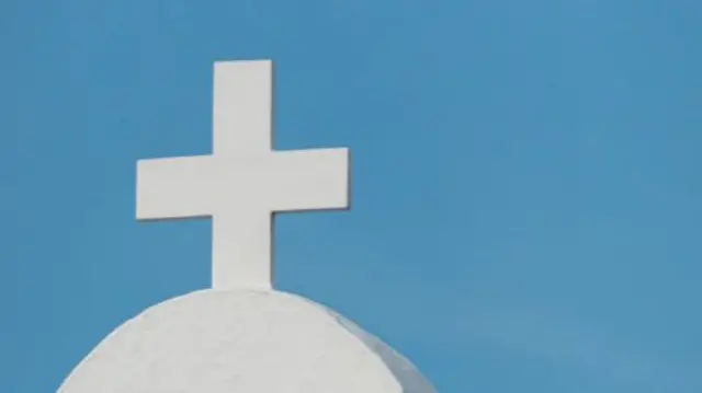 A cross on top of a church.