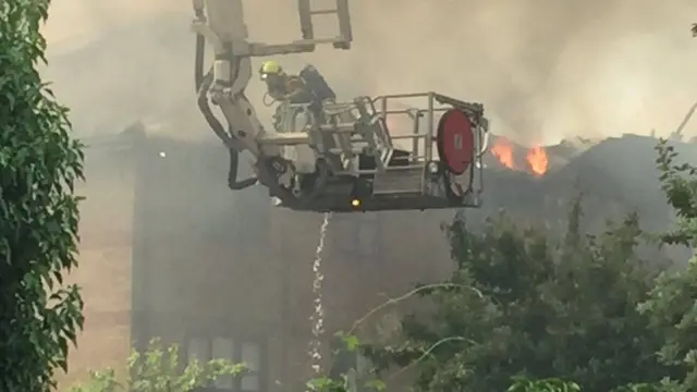 An aerial ladder being used to fight the flames