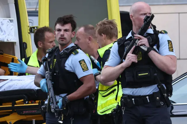 Armed police are seen during the evacuation of people at the Fields shopping center in Copenhagen, Denmark, on July 3, 2022