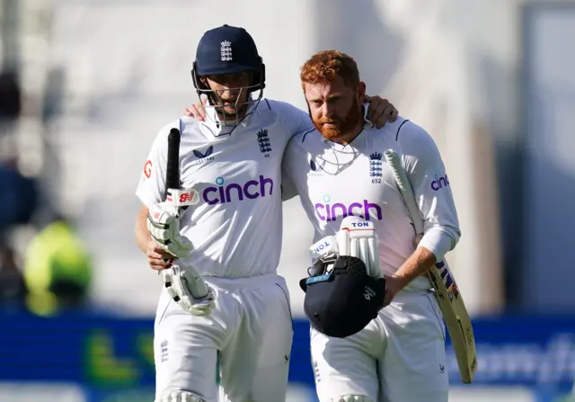 Joe Root and Jonny Bairstow with their arms round each other as they leave the field on Day 4 of the Test v India