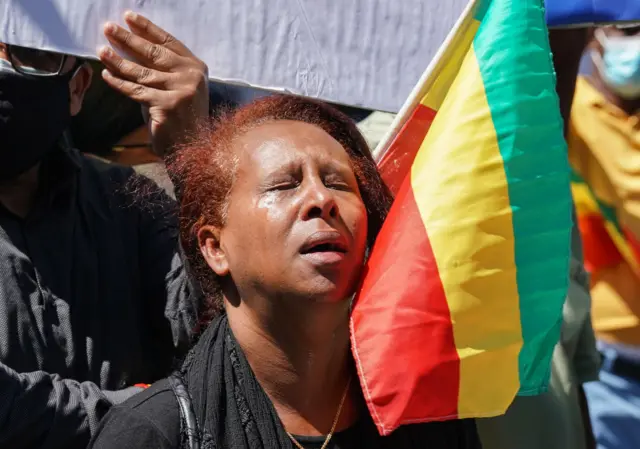 A woman from the Ethiopian community cries as other community members mourn during a demonstration to bring awareness to the mass ethnic cleansing of ethnic Amharas in the Gimby Zone in Western Wollege, Oromia Region in Ethiopia on June 30, 2022 in Washington, DC.