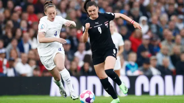 A photo of England and Austria women playing football