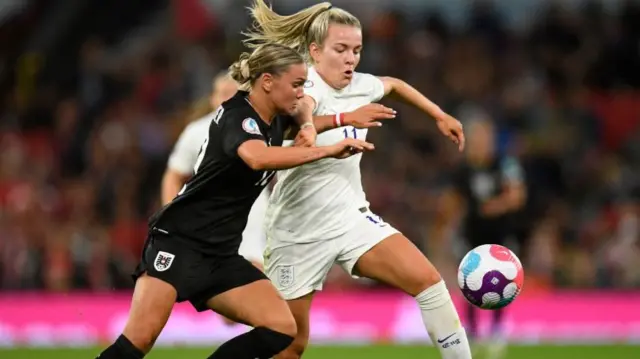 A photo of England and Austria women playing football