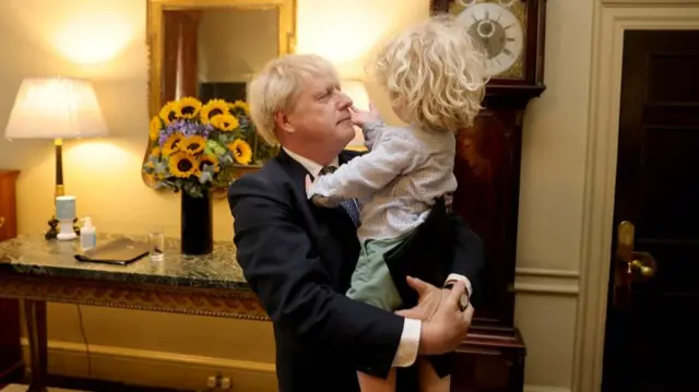 Johnson hugs his son Wilfred