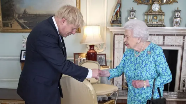 Boris Johnson shakes hands with the Queen