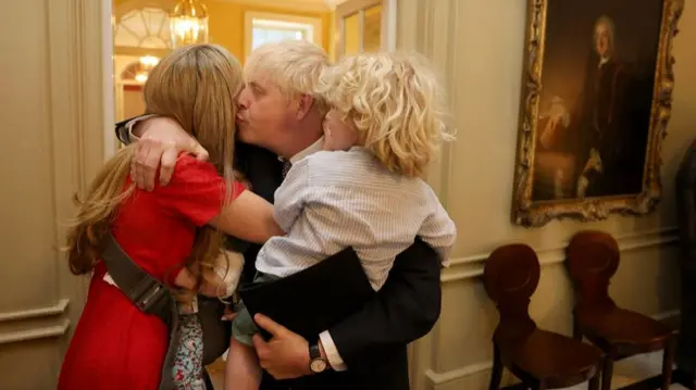 Johnson with his wife Carrie and their children