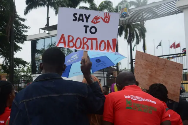 Protesters hold placards during a peaceful rally following a press statement released by the Lagos State Government on abortion guidelines in Lagos - 30 June 2022