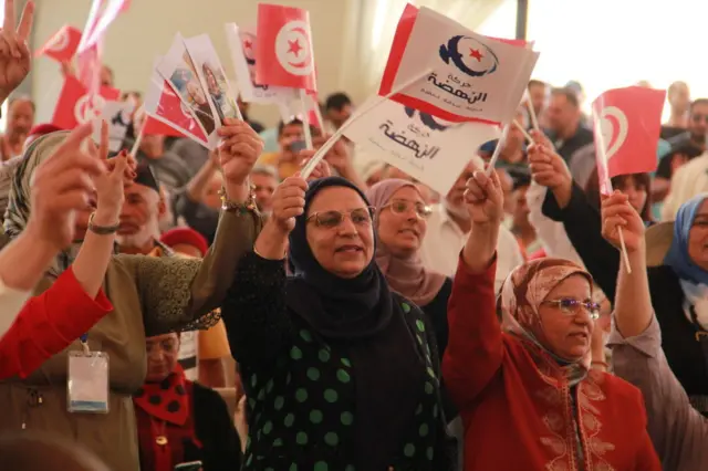 People wave flags as Rached Ghannouchi, leader of the Ennahda Movement and Speaker of the dissolved Tunisian Parliament attends a meeting held on the occasion of the 41st anniversary of the founding of the Ennahda Movement in Sfax city, Tunisia - 5 June 2022