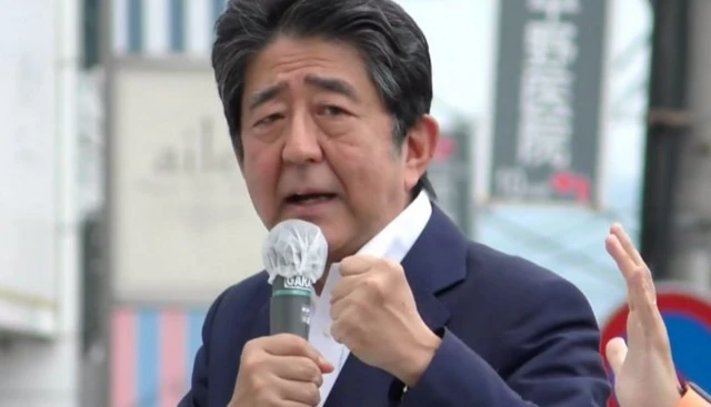 Former Japanese Prime Minister Shinzo Abe speaks to voters in support of his party's candidate during an Upper House election campaign outside Yamato-Saidaiji Station of Kintetsu Railway in Nara, western Japan