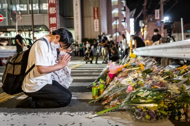 Man prayers on site where Shinzo Abe was shot