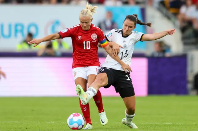 Pernille Harder of Denmark and Sara Däbritz of Germany fight for the ball