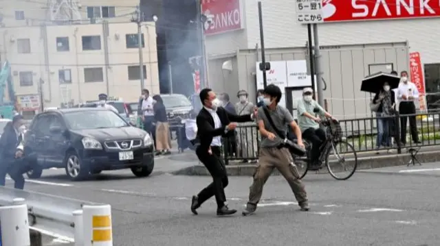 A police officer detains a man, believed to have shot former Japanese Prime Minister Shinzo Abe, in Nara, western Japan July 8, 2022