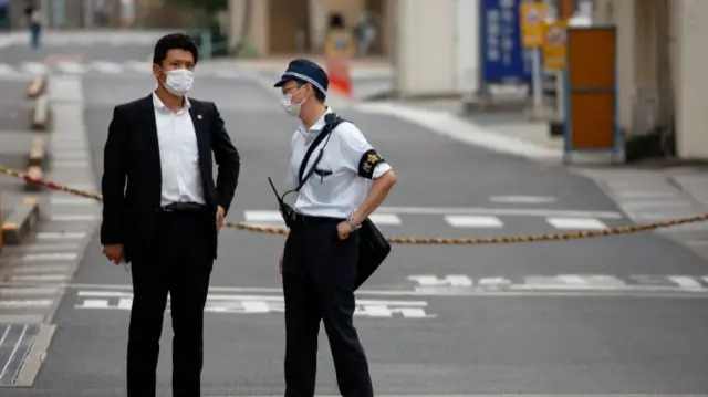 A police officer stands outside Nara Medical University Hospital where late former Japanese Prime Minister Shinzo Abe was taken after he was shot while campaigning for a parliamentary election, in Kashihara, Nara prefecture,