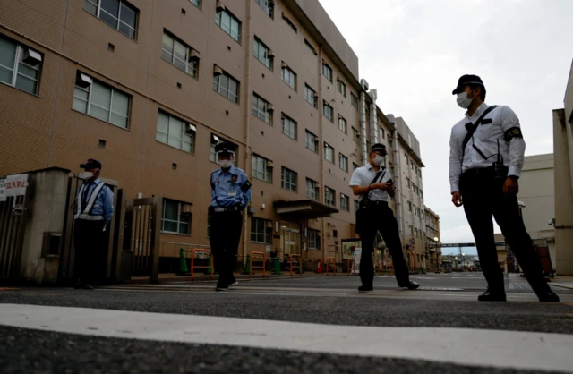 Police officers stand guard outside Nara Medical University Hospital where late former Japanese Prime Minister Shinzo Abe was taken