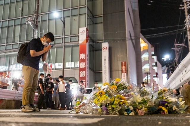 Man prayers at site where Shinzo Abe was shot