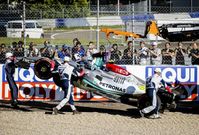 Lewis Hamilton's car is lifted away following his crash