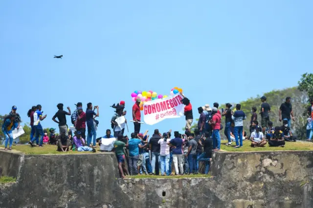 Fans hold a banner