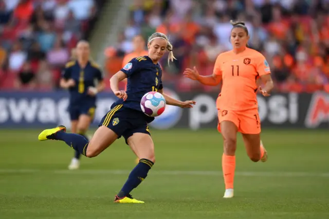 Amanda Ilestedt of Sweden is challenged by Lieke Martens